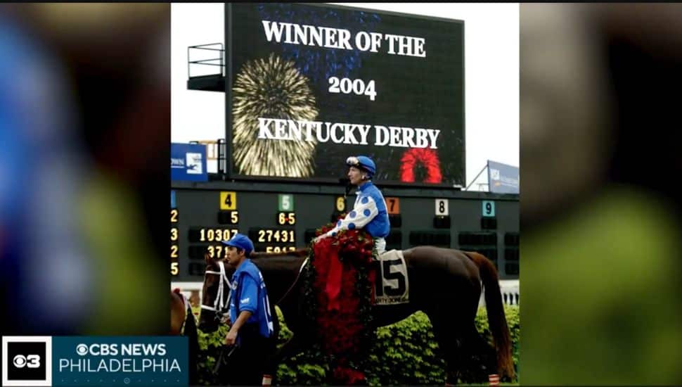 Smarty Jones after win in front of sign that reads "winner of 2004 Kentucky Derby."