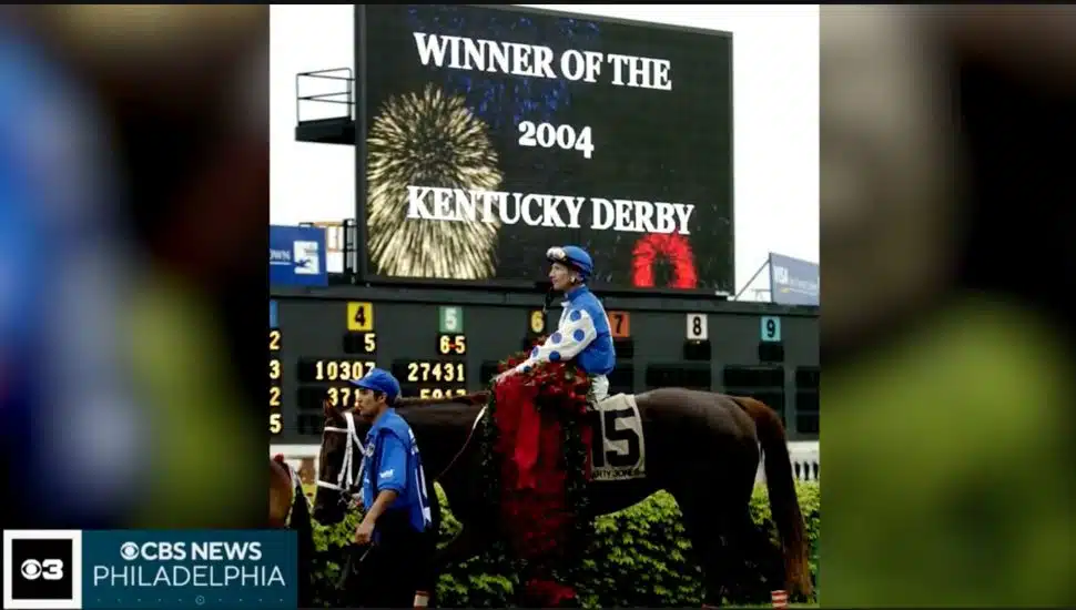 Smarty Jones after win in front of sign that reads "winner of 2004 Kentucky Derby."