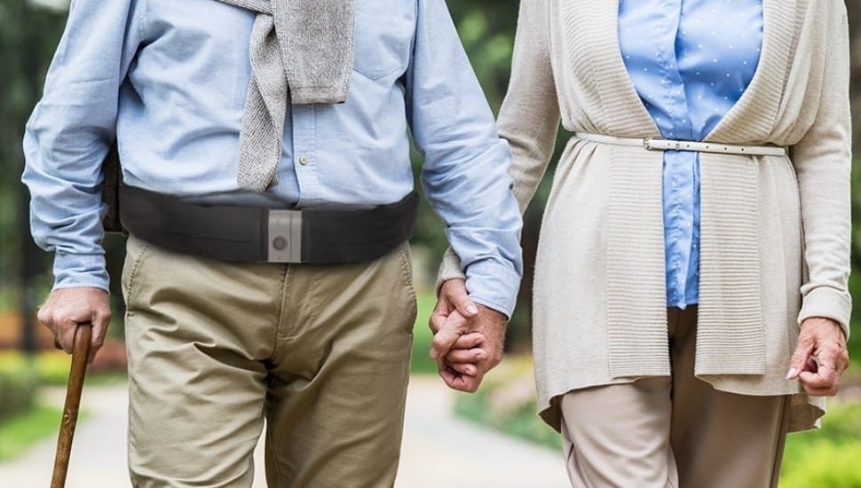 Elderly couple walking with man wearing Tango Belt.