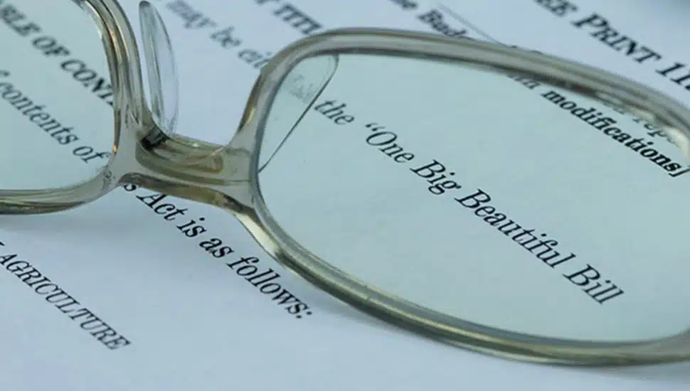 Eyeglasses sit on paper that says One Big Beautiful Bill Act.