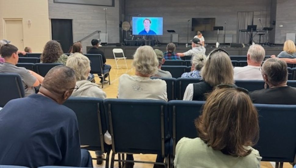 Audience seated in rows of chairs watching a presentation on suicide prevention during a QPR training session at Chester County Hospital.