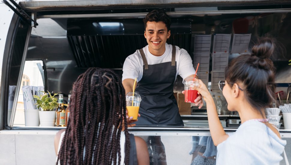 Person selling food out of food truck.