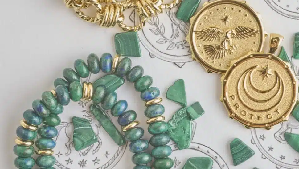 Two malachite necklaces and two gold bald eagle pendants from Jane Win Jewelry's new "Protect" collection.
