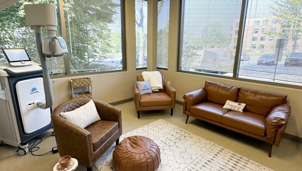 Office in mental health clinic with brown leather couch and seat.