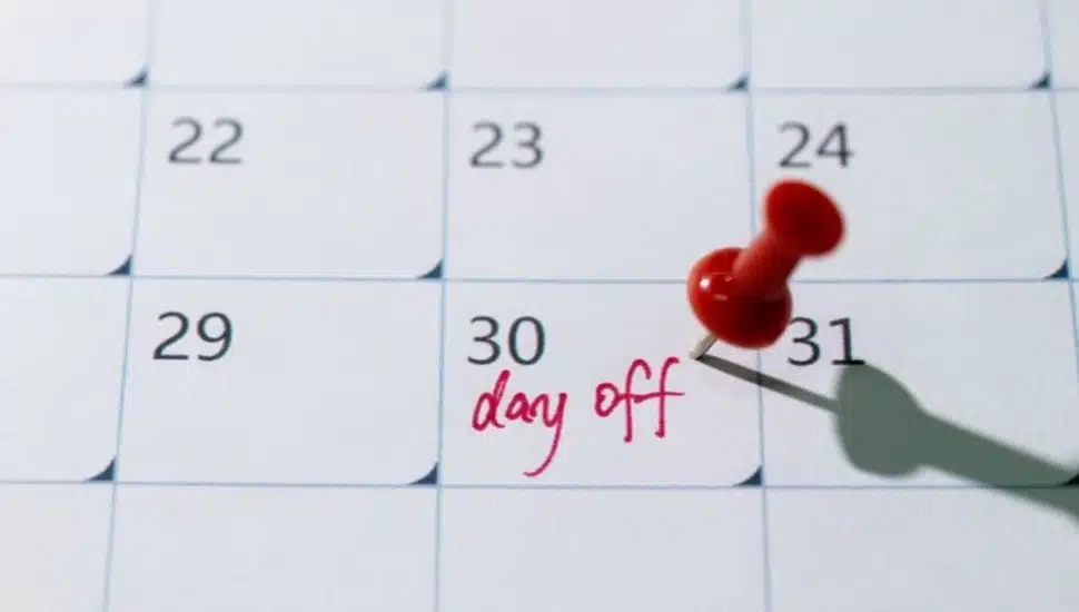 Calendar with red thumb tack on day off.