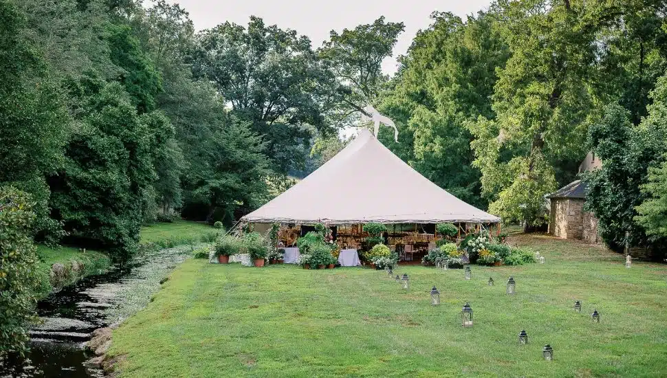 A tent and outdoor ceremony setup for a wedding at Winterthur Museum, Garden & Library.