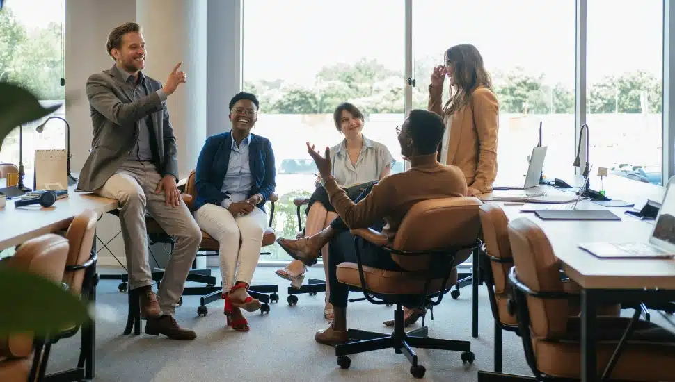 Company employees talking in an office.