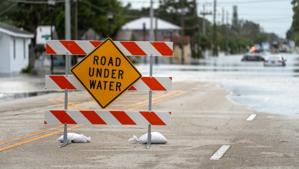 Sign to block flooded road.
