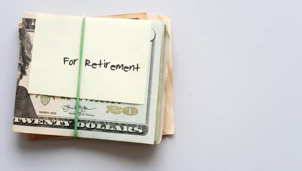 Cash wrapped with a rubber band and labeled "Retirement"