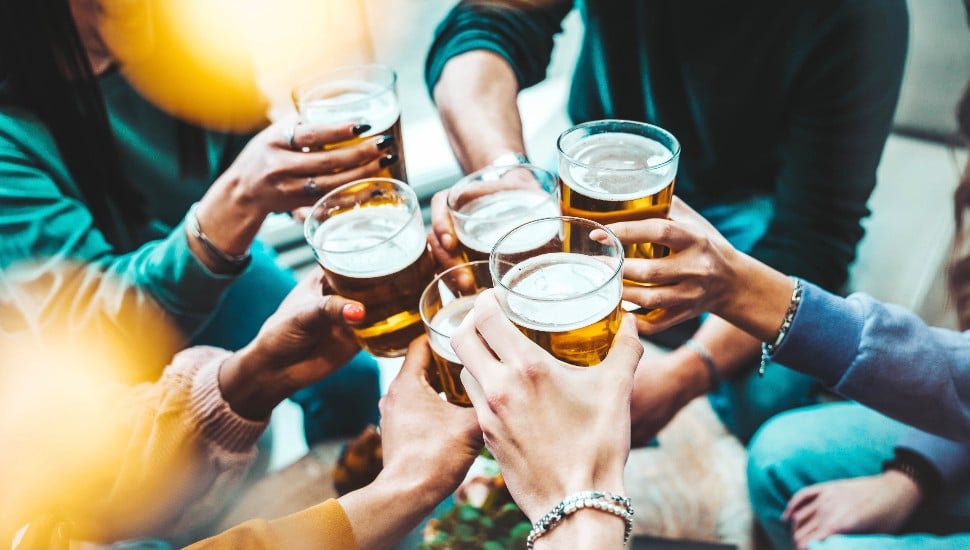 A group of people drinking beer at brewery pub restaurant.