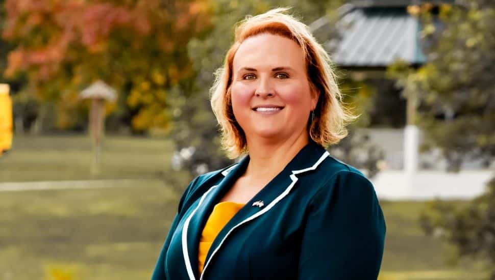 Erica Deuso in a blazer headshot.