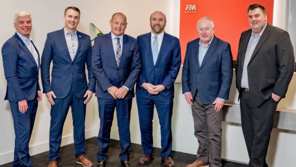 PM Group people in suits.