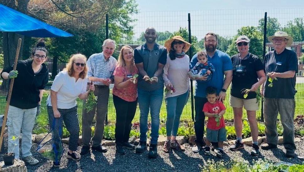 A group of people standing in Penn State Brandywine's garden.