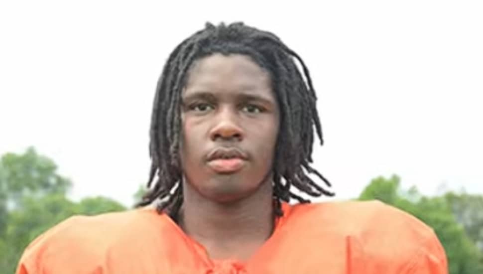 Shemai Henry in orange football uniform.