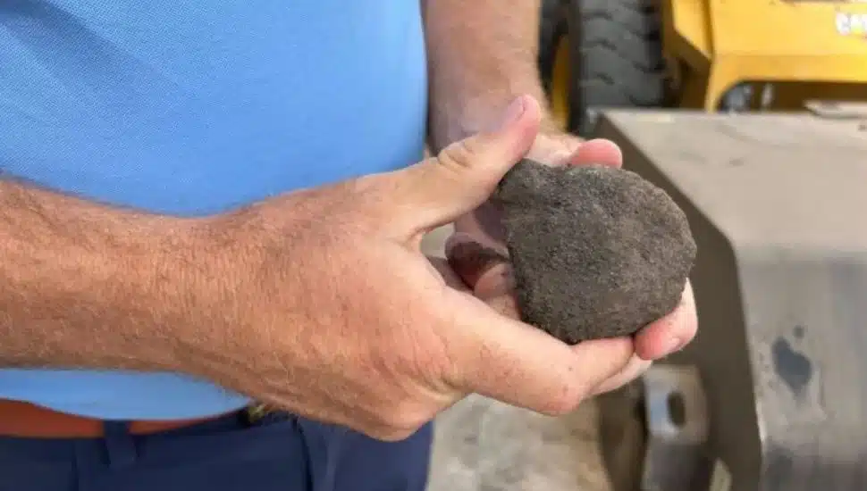 Dan Spracklin holds piece of biocoal.