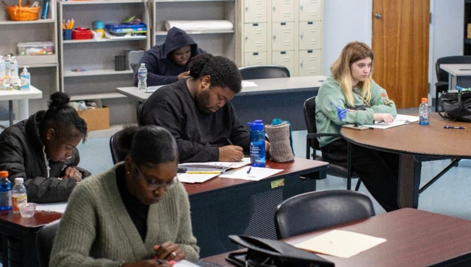 Participants in the CCOIC Work Enclave Fall Cohort focus on coursework during a professional development session, building skills for career advancement.