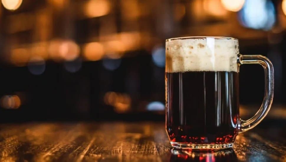 Close up of a beer mug on wood table.
