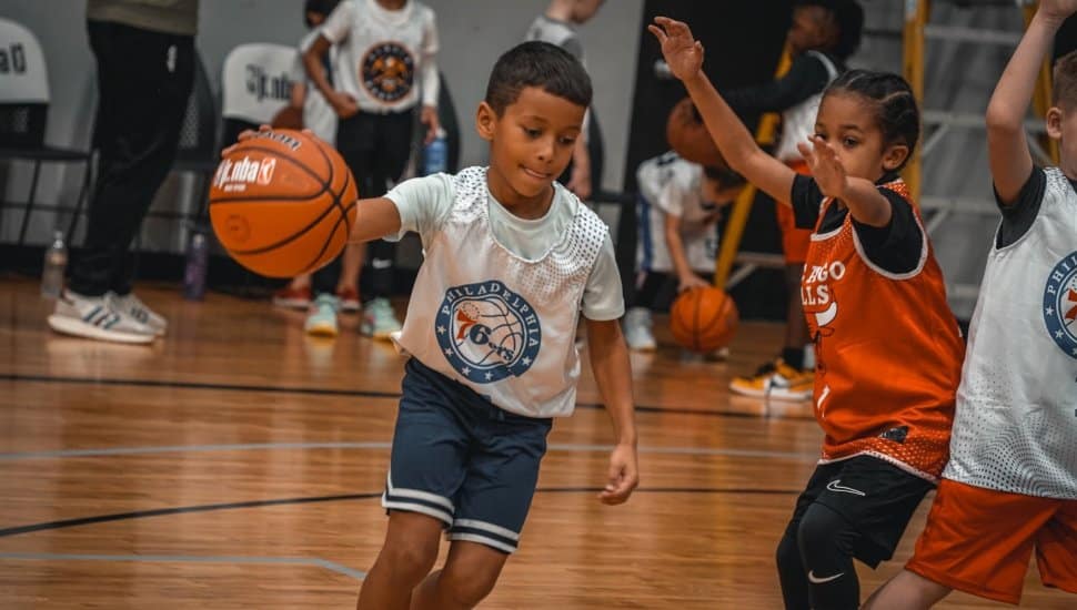 Children playing basketball in YMCA of Greater Brandywine’s new Jr. NBA league, showcasing teamwork and fun on the court.
