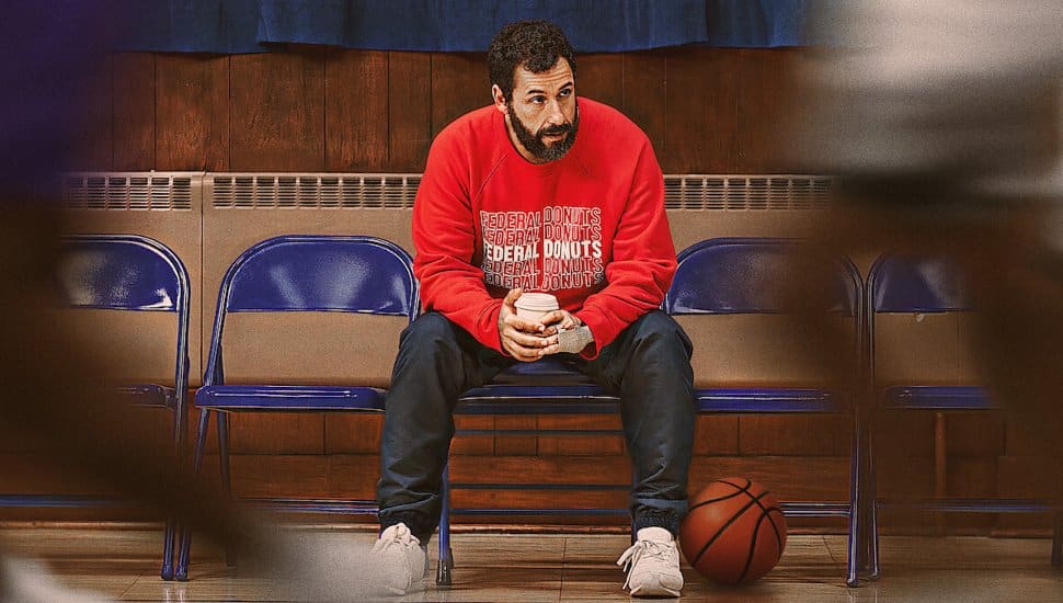 Adam Sandler screenshot in Hustle sitting a chair.