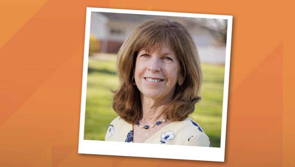 A portrait of Dr. Angela Herman wearing professional attire, smiling in an academic setting.