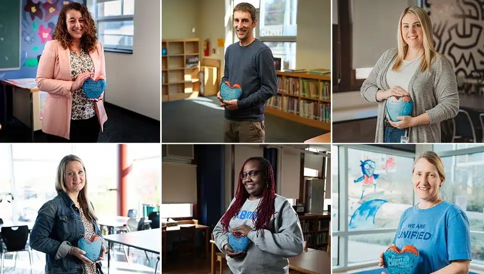 Six teachers hold glass heart award.
