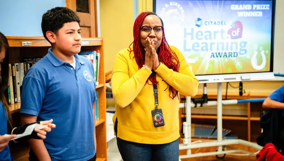 Teacher surprised to receive award in her classroom.
