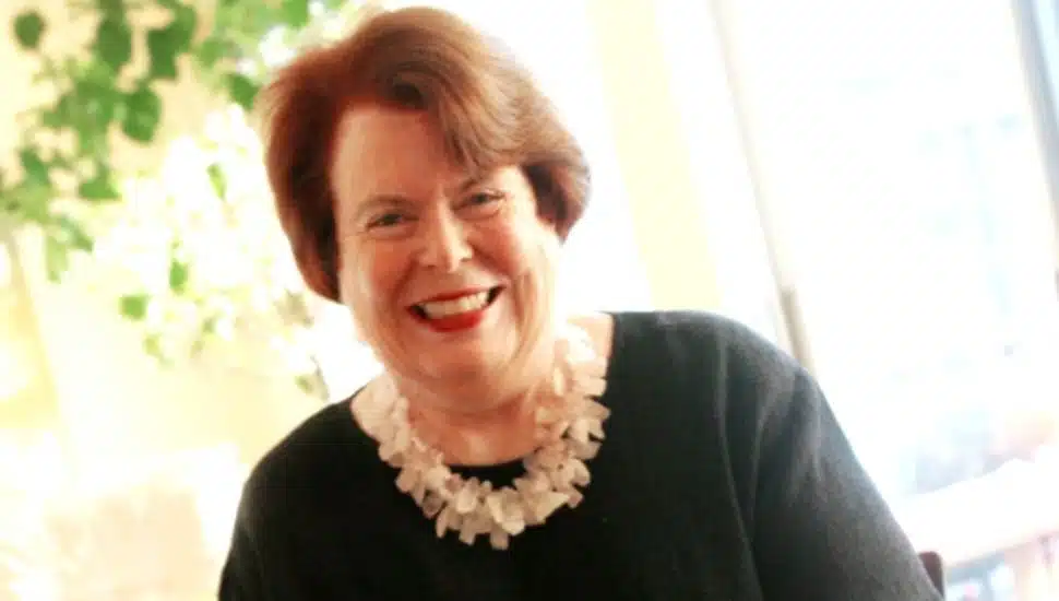 Eileen Moran Brown wearing white necklace and black shirt.
