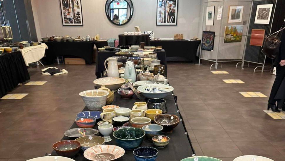 Empty Bowls Exton event with table full of pottery bowls.
