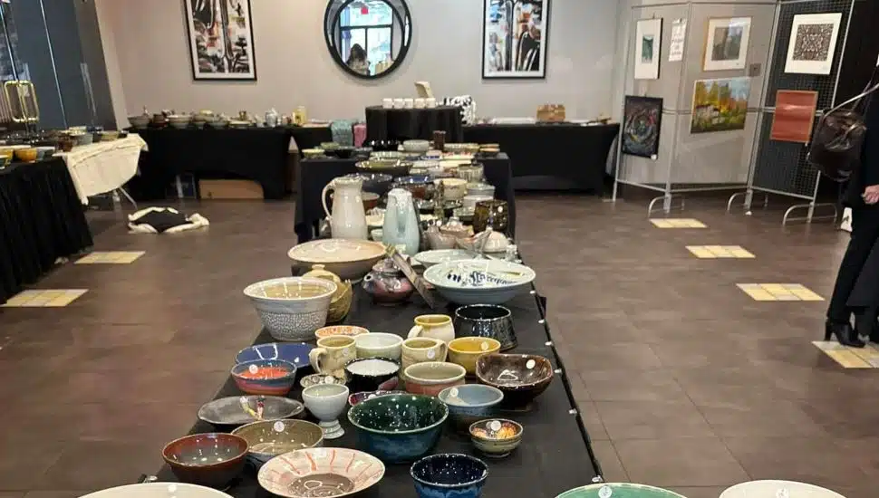 Empty Bowls Exton event with table full of pottery bowls.