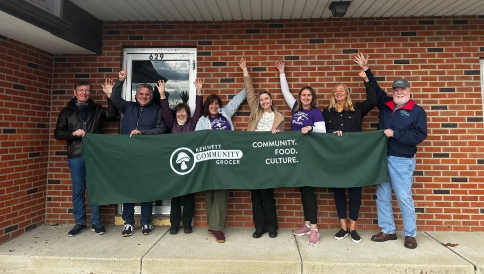 Kennett Community Grocer board members with a celebratory banner.