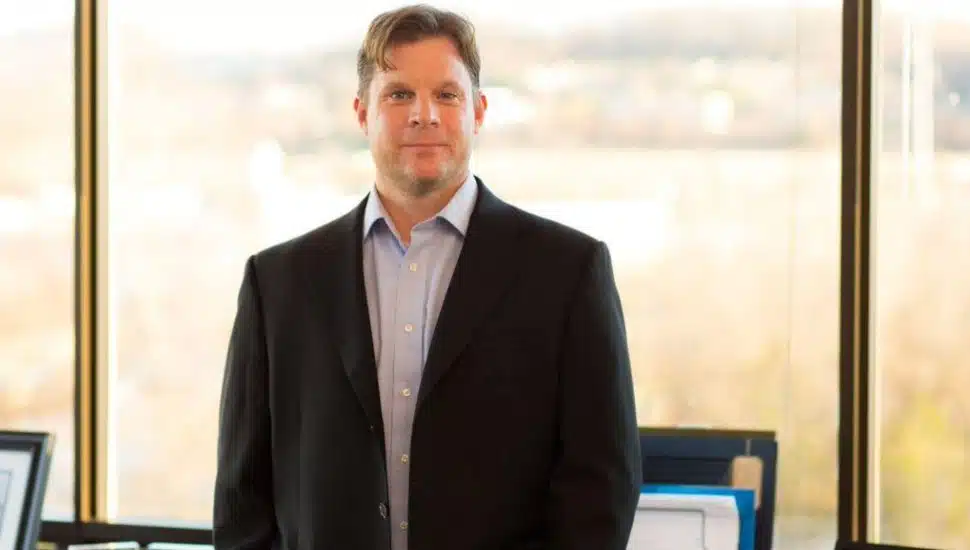CEO Neal Walker in a suit headshot.