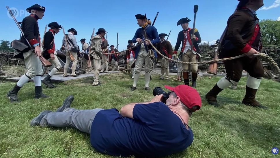 Photographer capturing a Revolutionary War reenactment.
