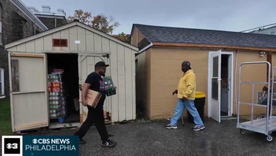 People walking with food from food drive.