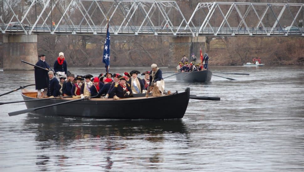 People on a boat for Washington Crossing Historic Park Reenactments.