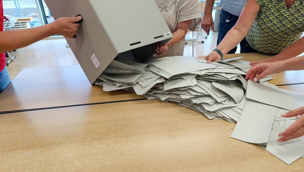 People dumping ballots out of box.