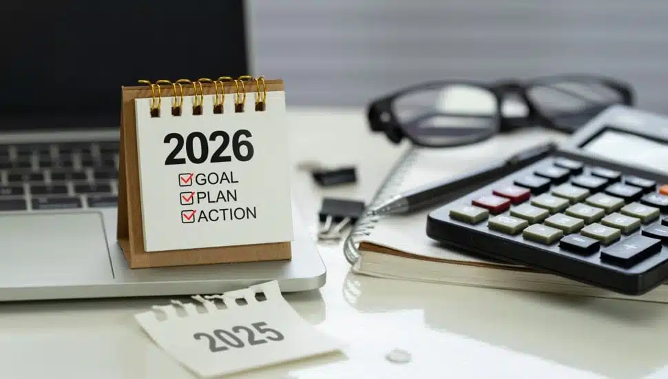 Desk calendar 2026 with checklist Goal, Plan, Action on office workspace.