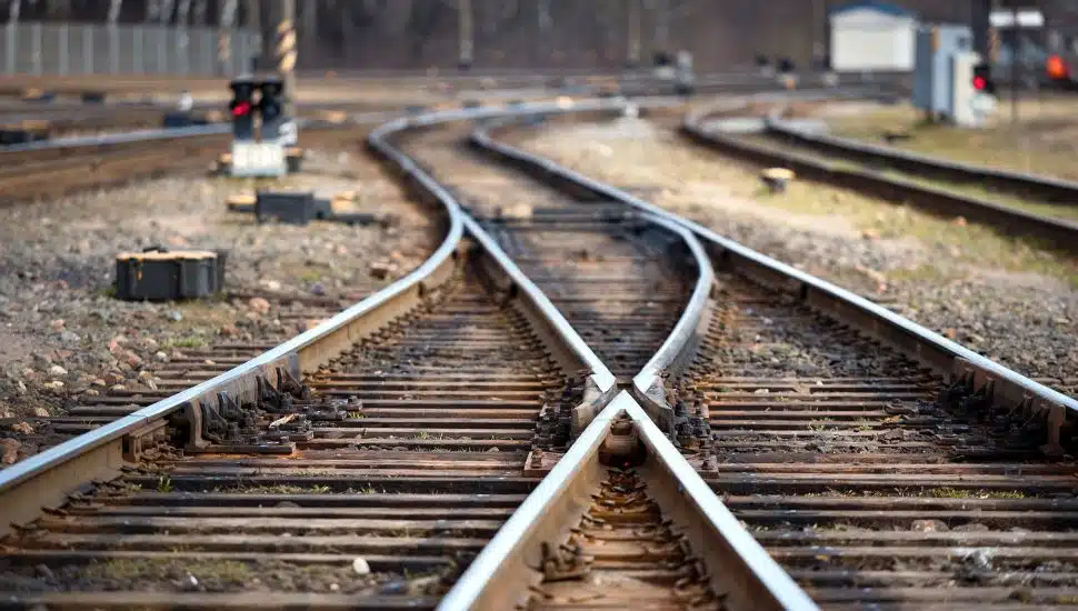 Empty railroad tracks at a fork.