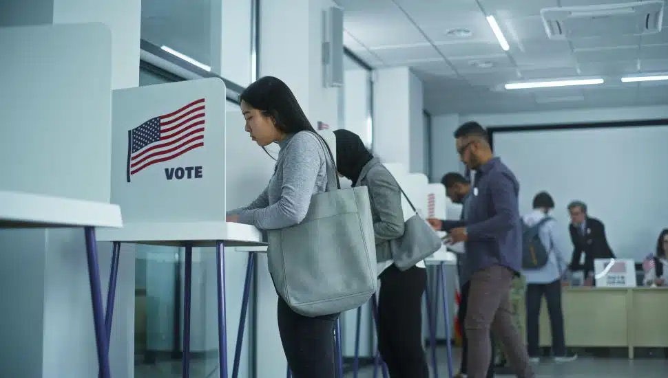 People voting at booths.