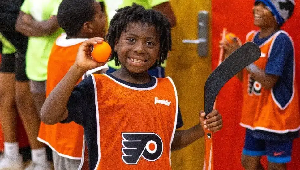 YGBW camper learns to play hockey at Camp Coatesville, one of eight YGBW summer camp locations accredited by the American Camp Association (ACA).
