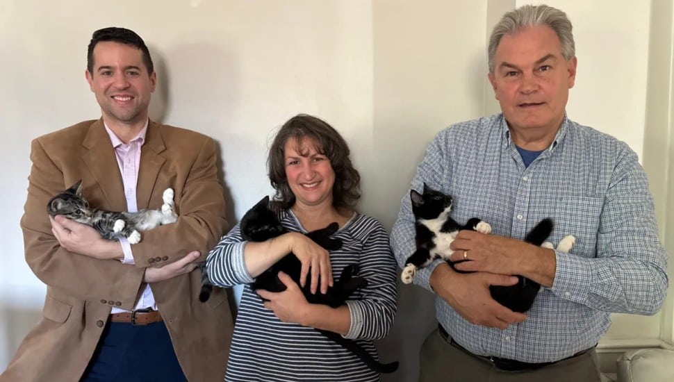 District Judge Lee Grives (left), Lisa Small and her husband Richard Small, hold cats.