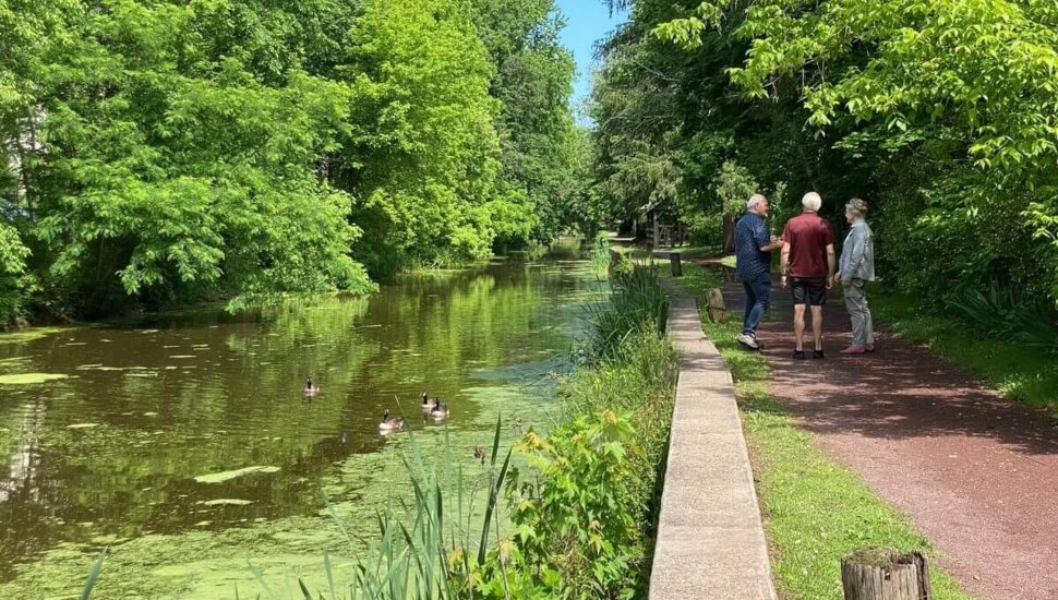 People on towpath next to creek.