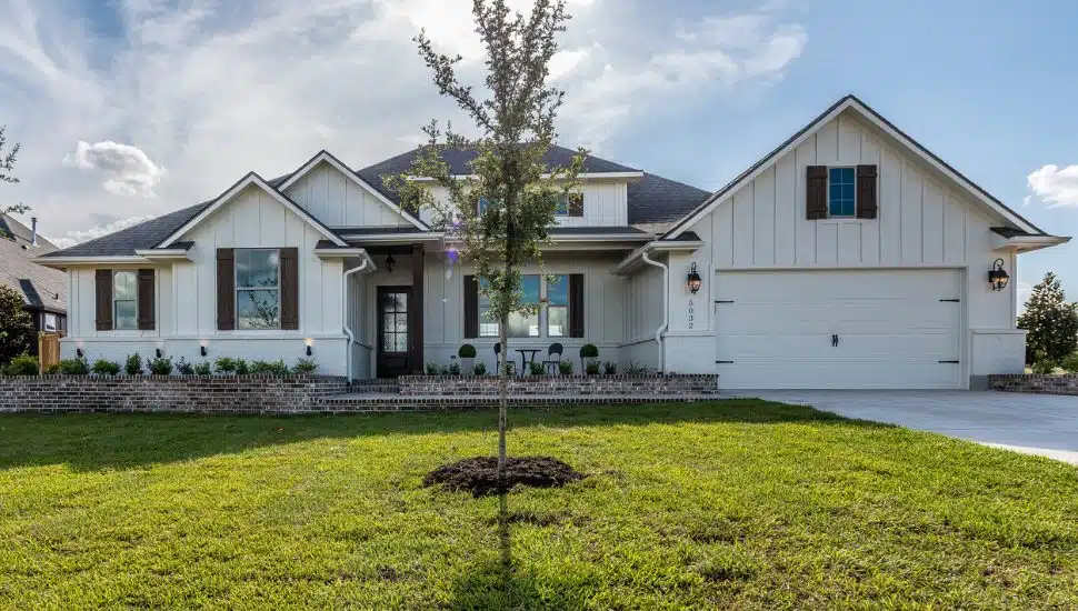 The exterior of a modern suburban farmhouse.
