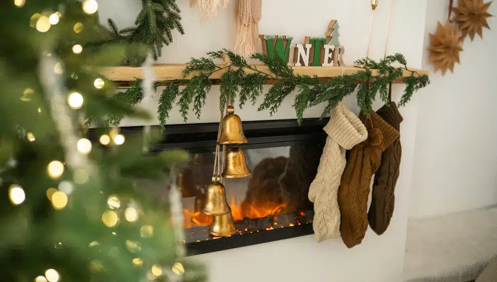 A festive holiday garland with surrounding holiday decor.