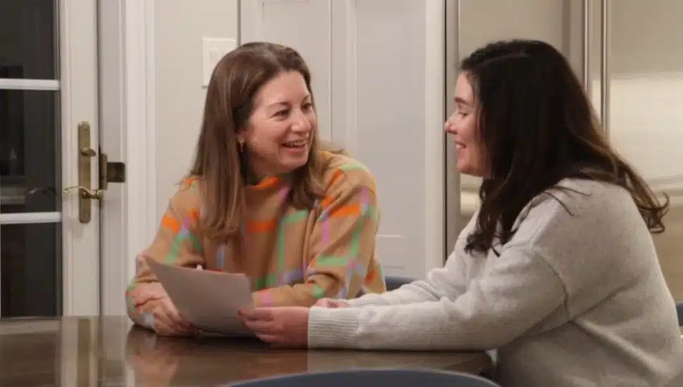 Megan Lewis and Dr. Suzanne Pugh sitting at a kitchen table.
