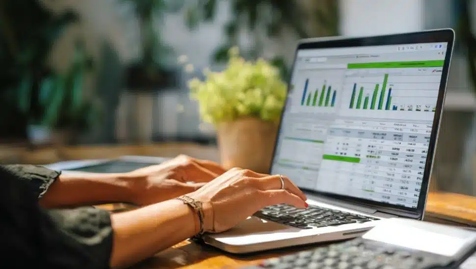 Woman works on financial portfolio from her laptop computer.