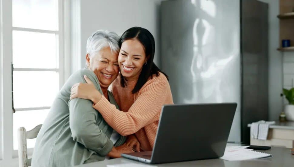 Senior mom and kid at computer exploring options.