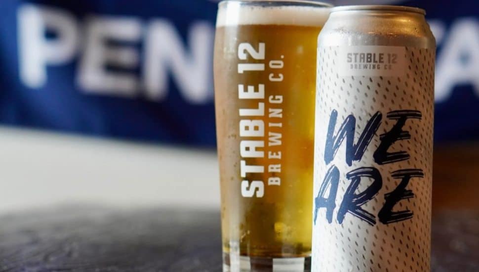 A can and glass of Stable 12 Brewing's We Are lager.