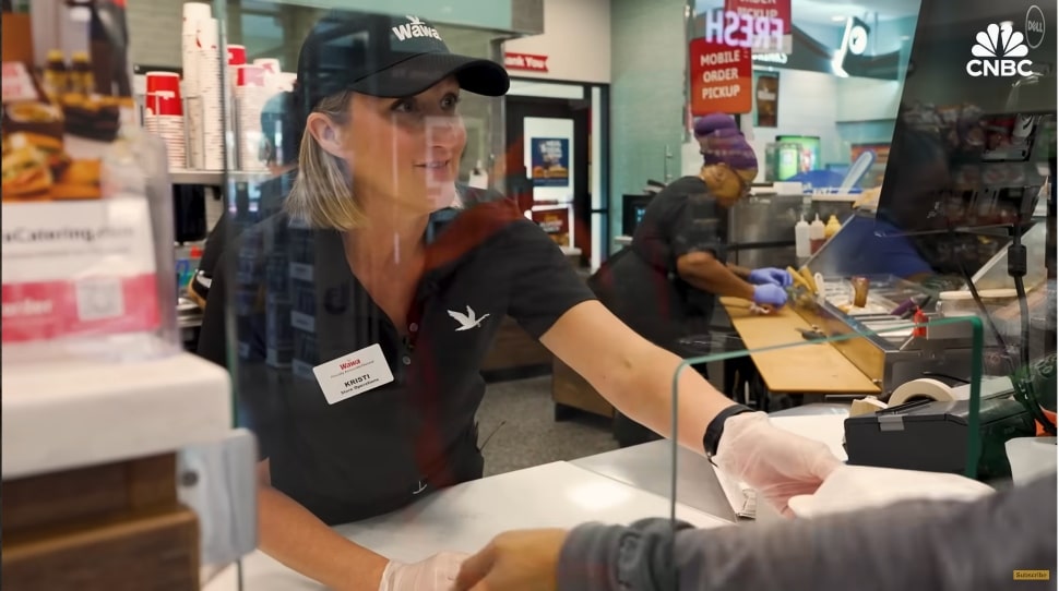 Wawa employee behind food counter.