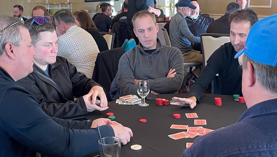 A group of men at a table playing poker.