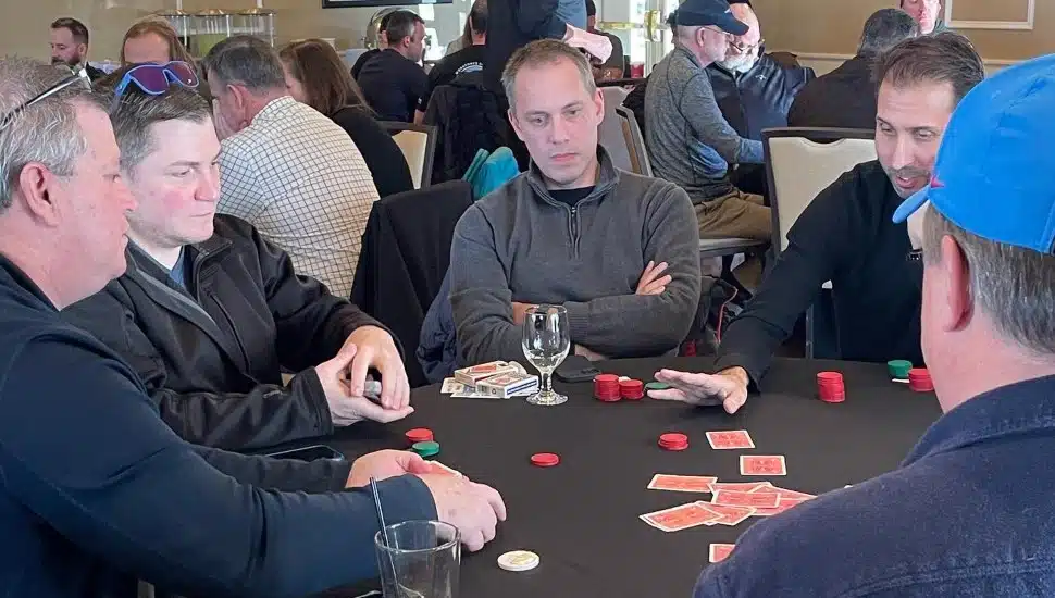 A group of men at a table playing poker.